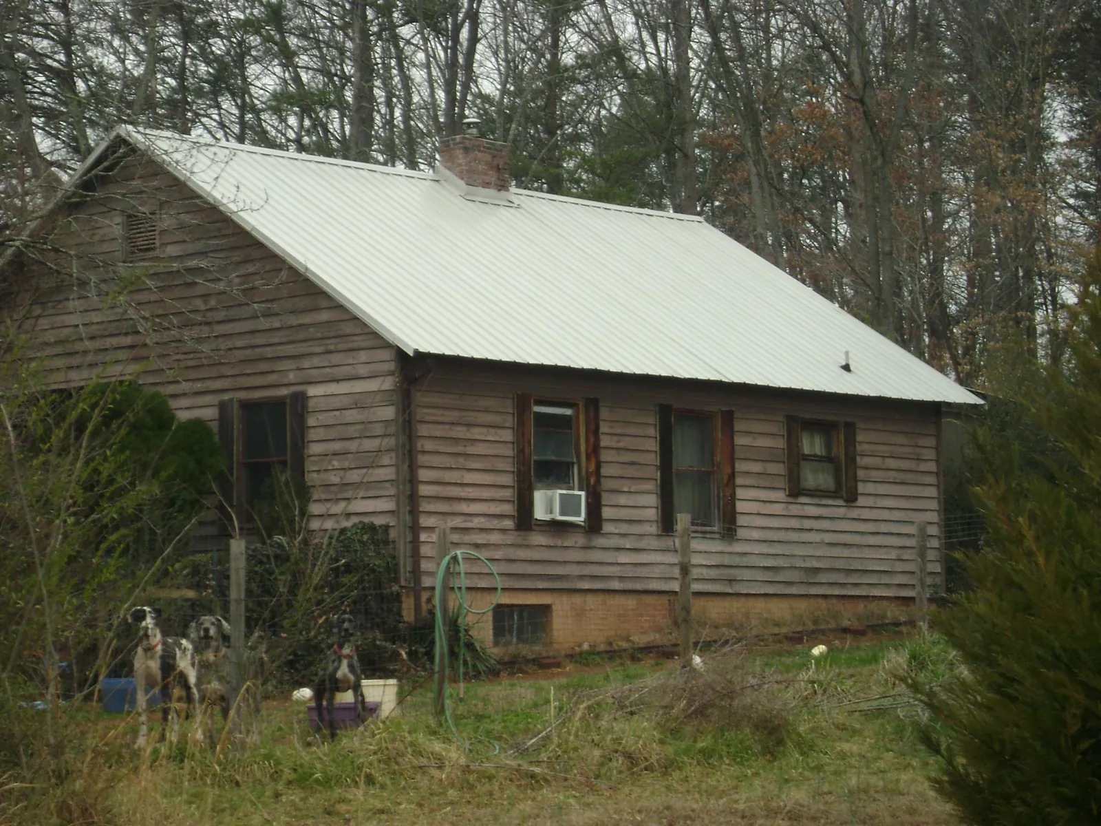 White metal roof on an old wood sided farmhouse, from a Asphalt Shingle Roof Repair job in Shelter Island Heights